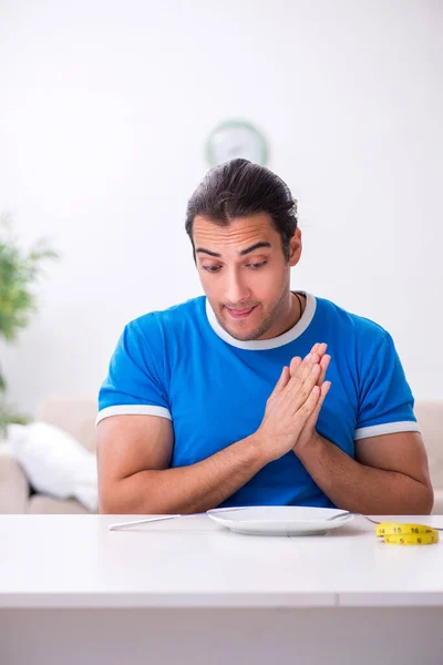 Jovem faminto no conceito de dieta — Fotografia de Stock