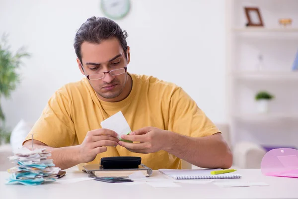 Young man in budget planning concept — Stock Photo, Image