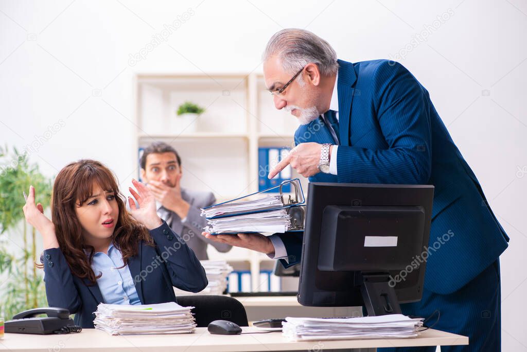 Two male and one female employees working in the office