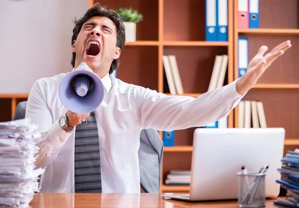 Young handsome businessman unhappy with excessive work — Stock Photo, Image