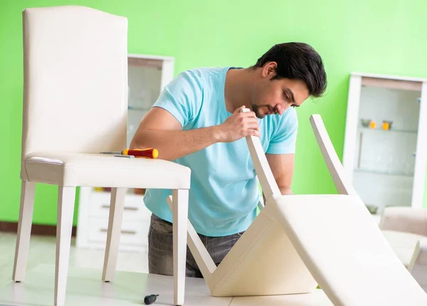 Man repairing furniture at home