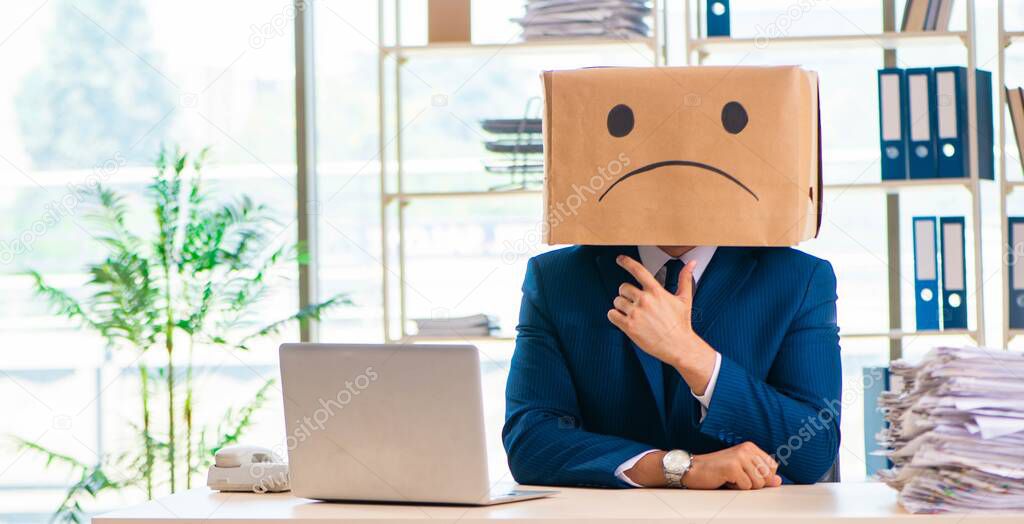 Unhappy man with box instead of his head