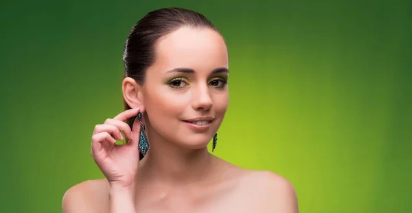 Young woman in beauty concept on green background — Stock Photo, Image