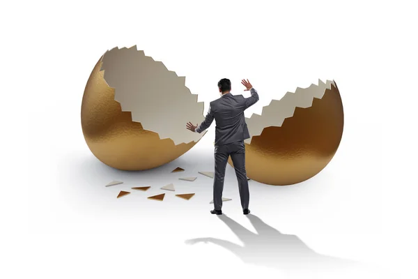 Businessman breaking out of golden egg — Stock Photo, Image