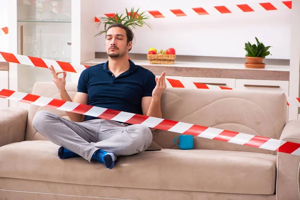 Young man feeling bored at home in self-isolation concept — Stock Photo, Image