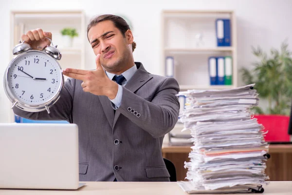 Young male businessman unhappy with excessive work — Stock Photo, Image