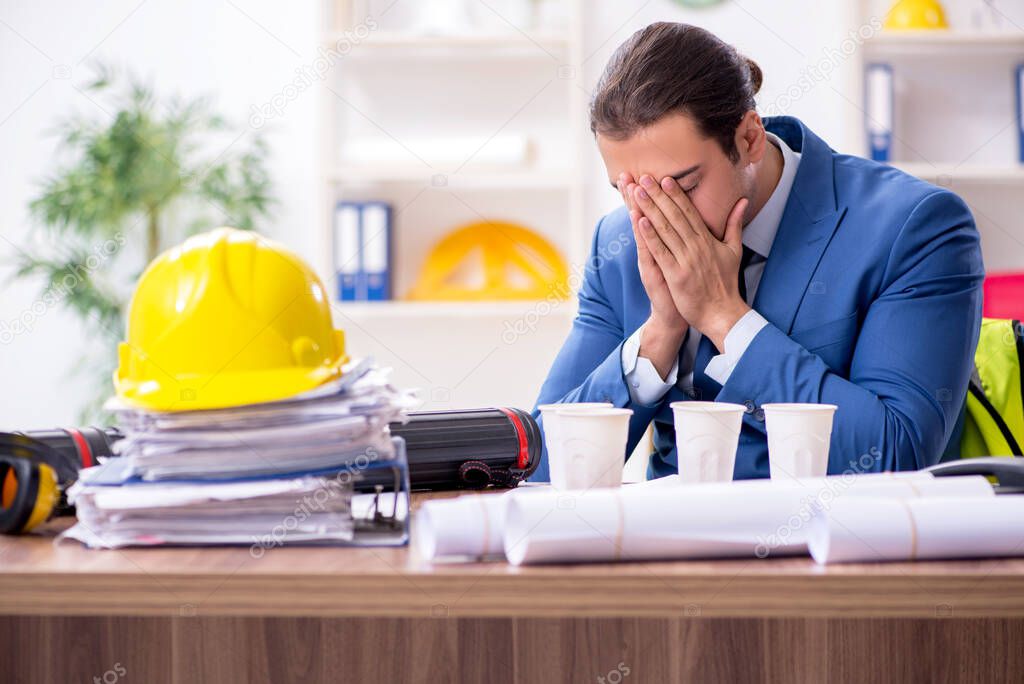 Young male architect working in the office