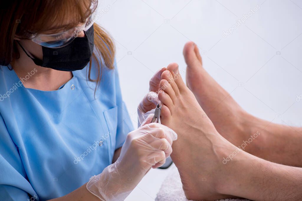 Podiatrist treating feet during procedure