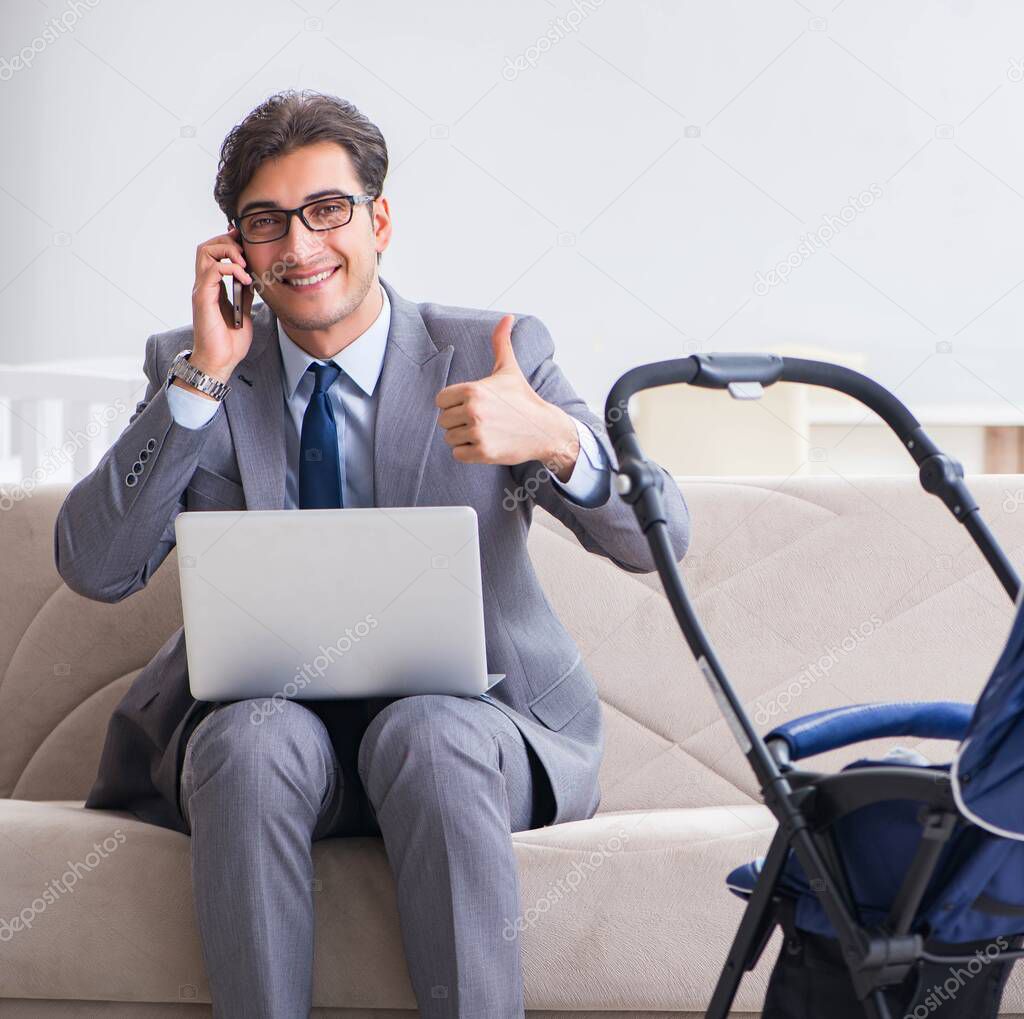 Businessman looking after newborn baby at home and teleworking