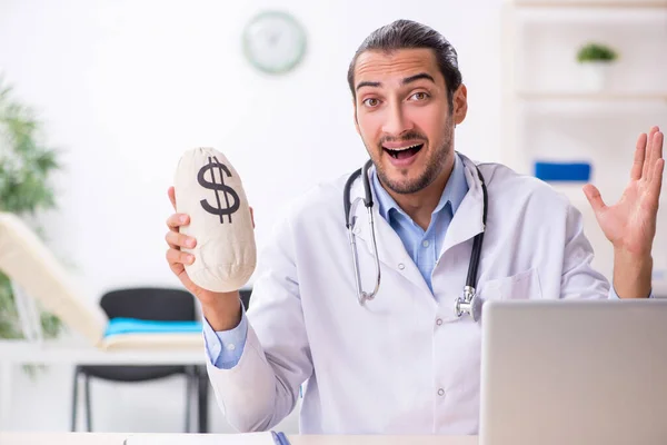 Young handsome male doctor working in the clinic — Stock Photo, Image