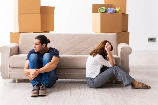 Young pair and many boxes in divorce settlement concept