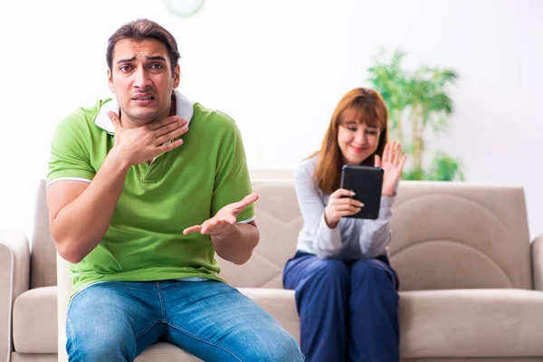 Pareja joven en concepto de dependencia gadget — Foto de Stock