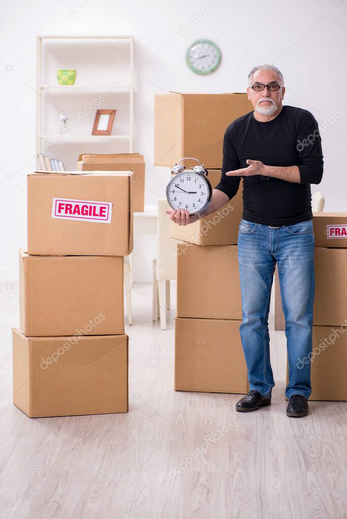 Old male professional mover doing home relocation