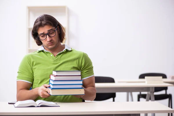 Young male student in the classroom — Stock Photo, Image
