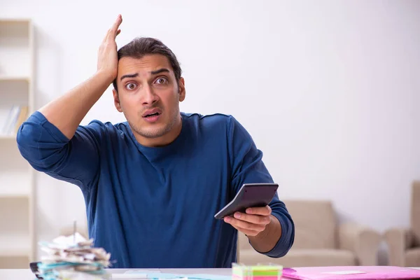 Young man in budget planning concept — Stock Photo, Image