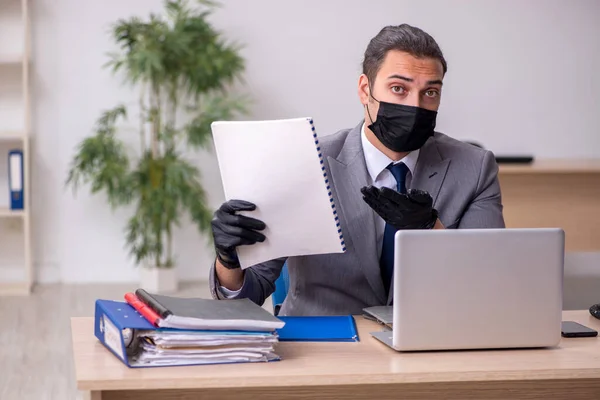 Jeune employé masculin au bureau pendant une pandémie — Photo