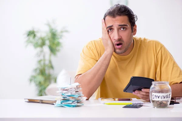 Young man in budget planning concept — Stock Photo, Image