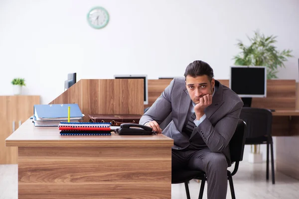 Young male employee unhappy with excessive work — Stock Photo, Image