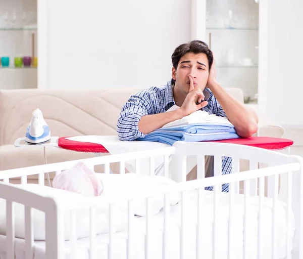 Young dad looking after newborn baby