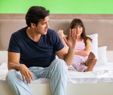 Woman and man in the bedroom after conflict clipart
