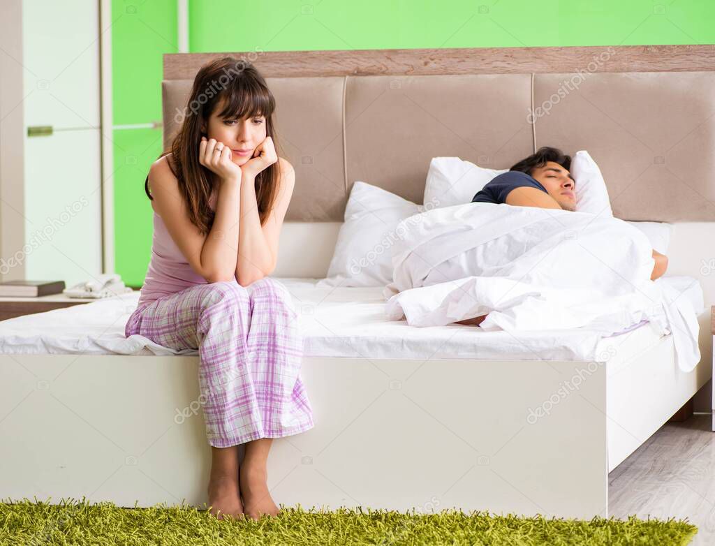 Woman and man in the bedroom after conflict