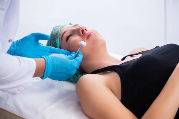 Mujer joven visitando dermatólogo médico masculino — Foto de Stock