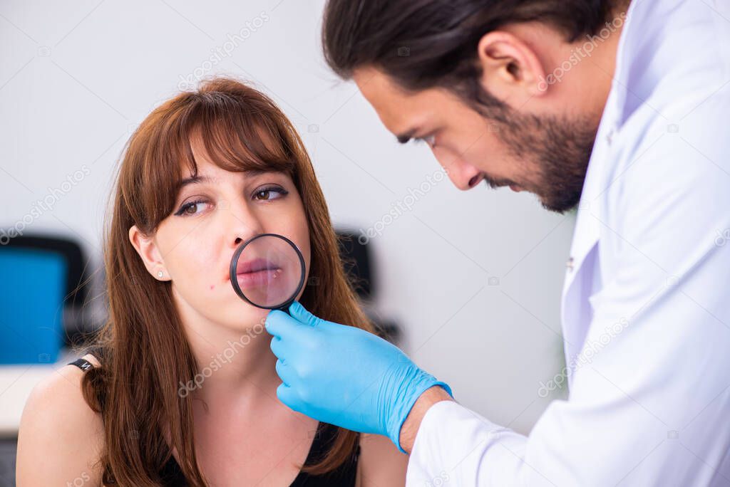 Young woman visiting male doctor dermatologist