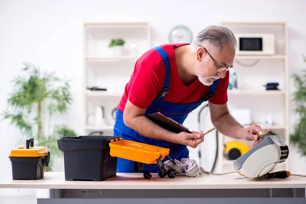 Viejo contratista reparando aire acondicionado en interiores — Foto de Stock