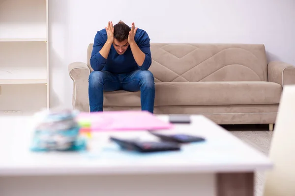 Young man in budget planning concept — Stock Photo, Image