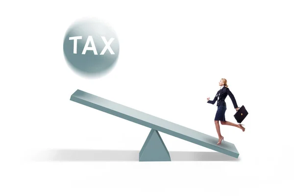 Businesswoman in tax concept with seesaw — Stock Photo, Image