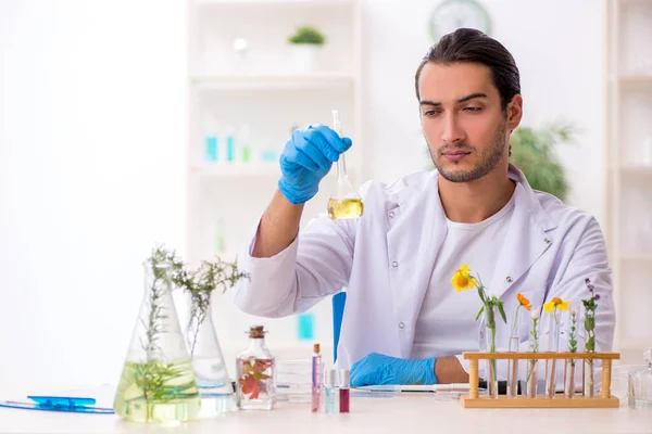 Young male chemist in perfume synthesis concept — Stock Photo, Image