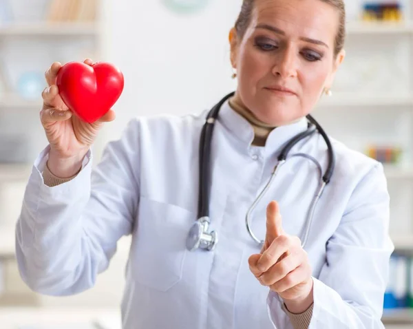 Cardiologist with red heart in medical concept — Stock Photo, Image