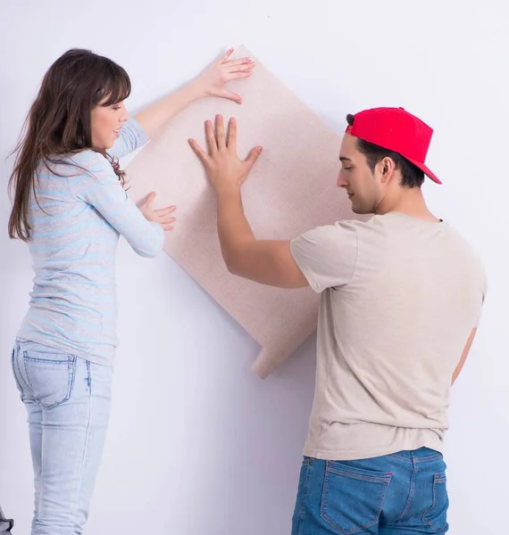 Young family doing renovation at home with new wallpaper — Stock Photo, Image