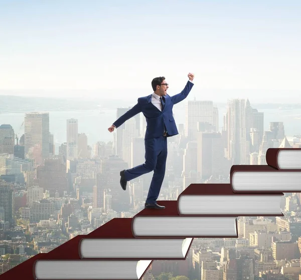 Businessman student climbing the ladder of education books — Stock Photo, Image