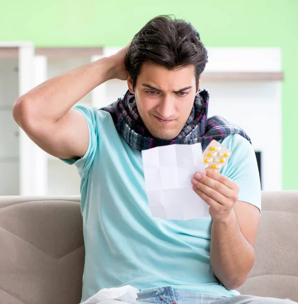 Young handsome man suffering from illness at home — Stock Photo, Image