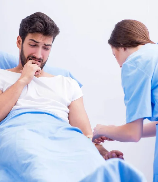 Lekarz badający pacjenta płci męskiej w szpitalu — Zdjęcie stockowe