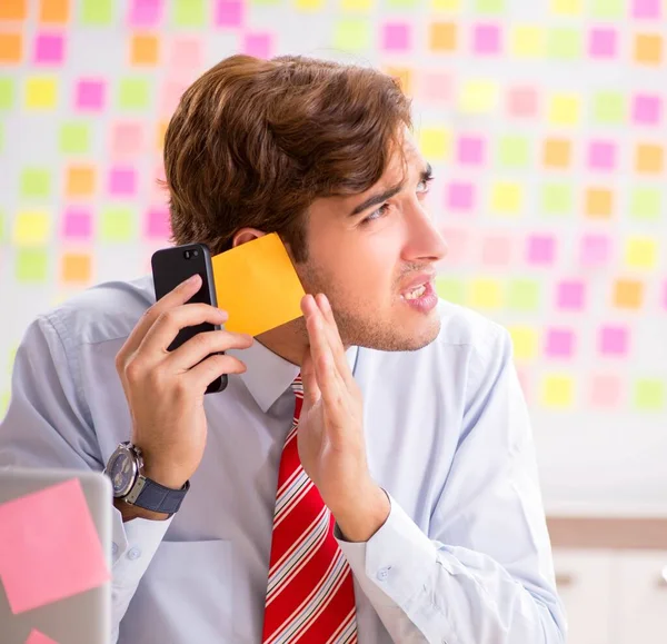 Young handsome man in conflicting priorities concept — Stock Photo, Image