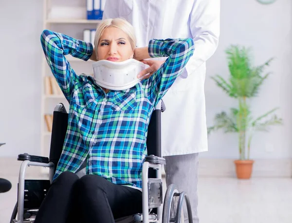 Disabled woman in wheel chair visiting man doctor