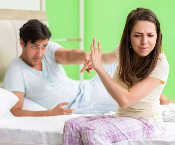 Woman and man in the bedroom during conflict — Stock Photo, Image