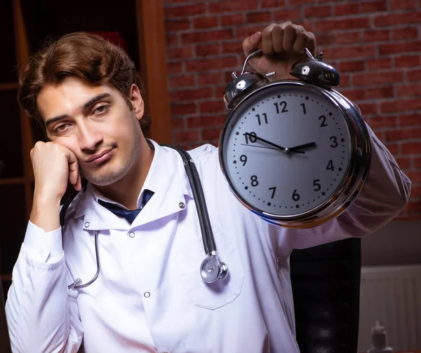 Mladý pohledný lékař pracovní noc v nemocnici — Stock fotografie