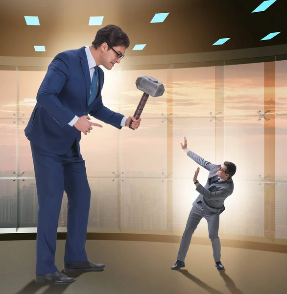 Bad angry boss threatening employee with hammer — Stock Photo, Image