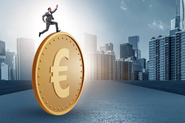 Businessman with giant golden euro coin — Stock Photo, Image