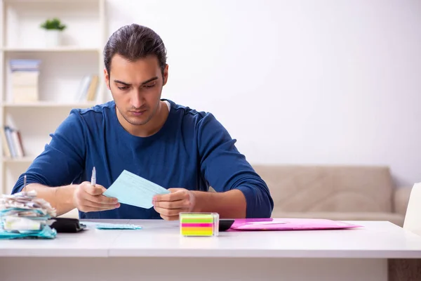 Young man in budget planning concept — Stock Photo, Image