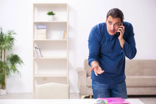 Young man in budget planning concept — Stock Photo, Image