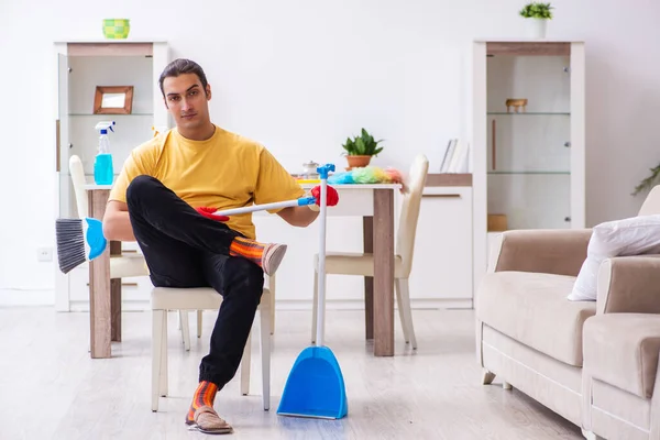 Young male contractor cleaning the house — Stock Photo, Image