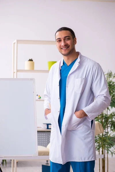 Joven médico masculino en concepto de presentación — Foto de Stock