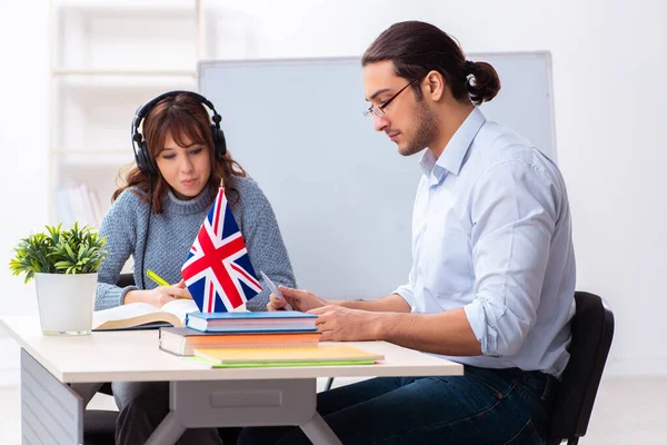 Young female student and male english teacher in the classroom — Stock Photo, Image