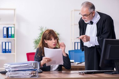 Yaşlı erkek yargıç ve genç sekreteri ofiste.