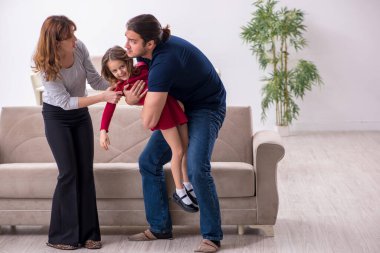 Young couple and their daughter in family conflict concept clipart