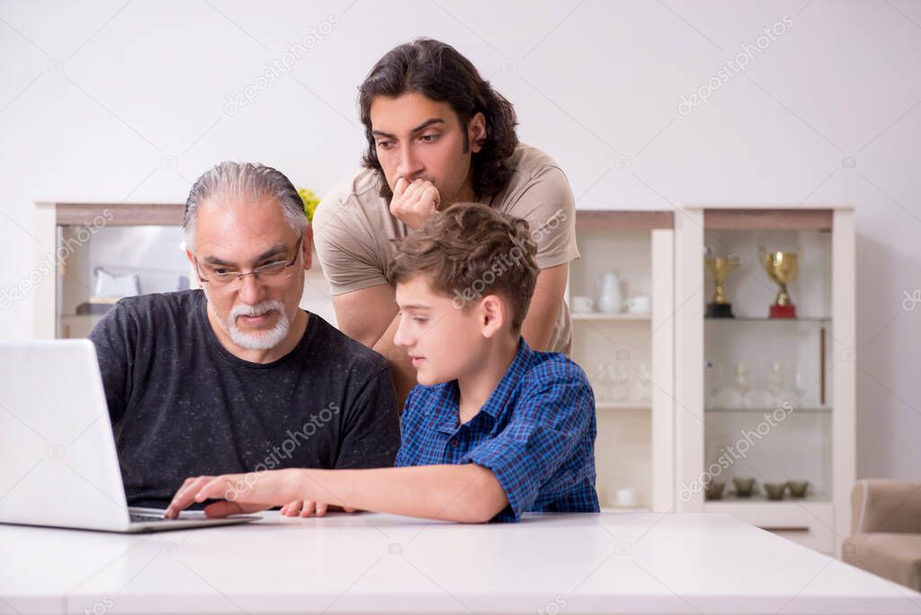 Grandfather learning new technology from son and grandson